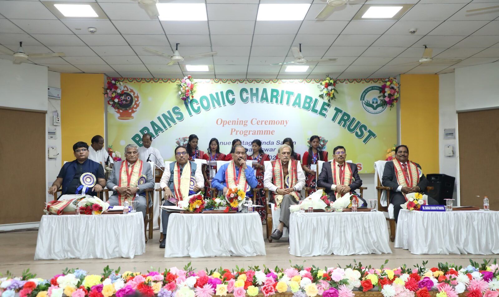 Dignitaries seated on stage at the Brains Iconic Charitable Trust Opening Ceremony Programme in Bhubaneswar.