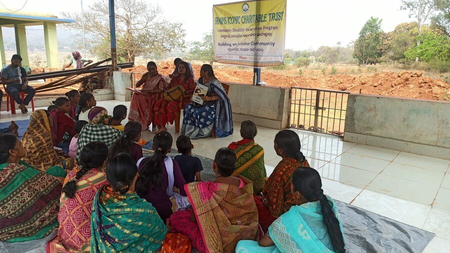 Women and children at a Women Empowerment Programme session in Dumuridihi.