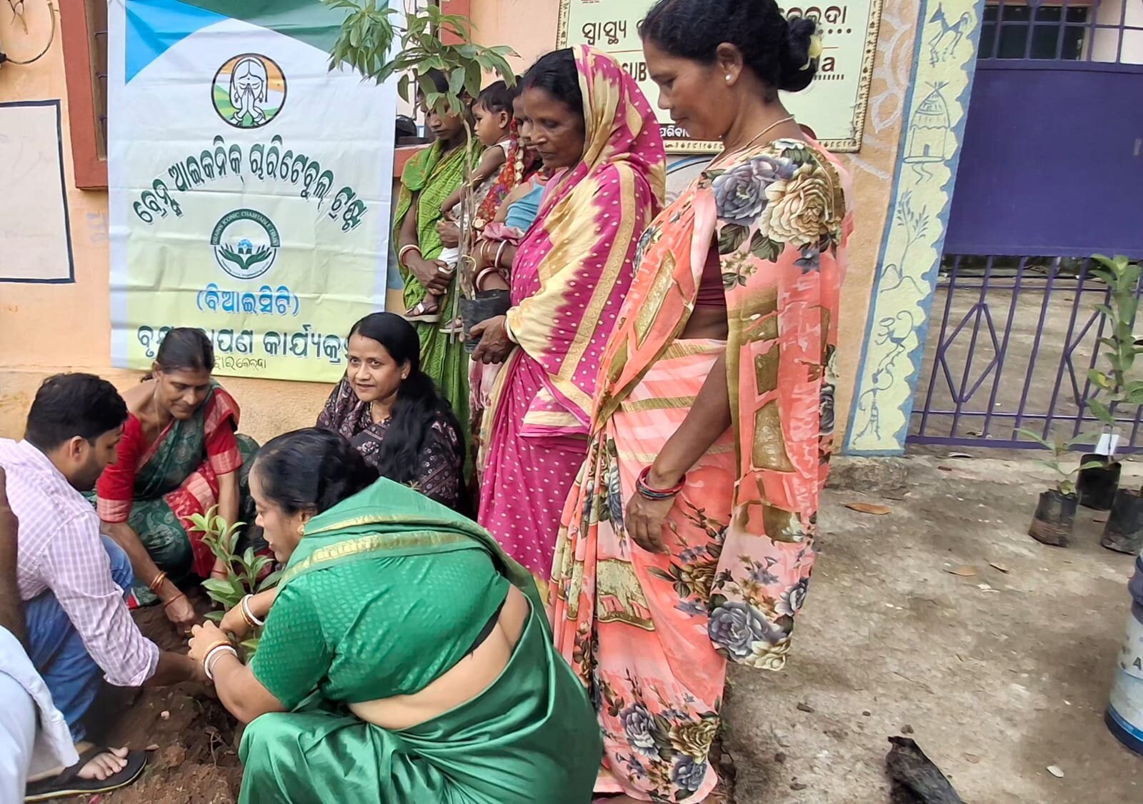 Community members gathered beneath the Brains Iconic Charitable Trust tree plantation programme banner.